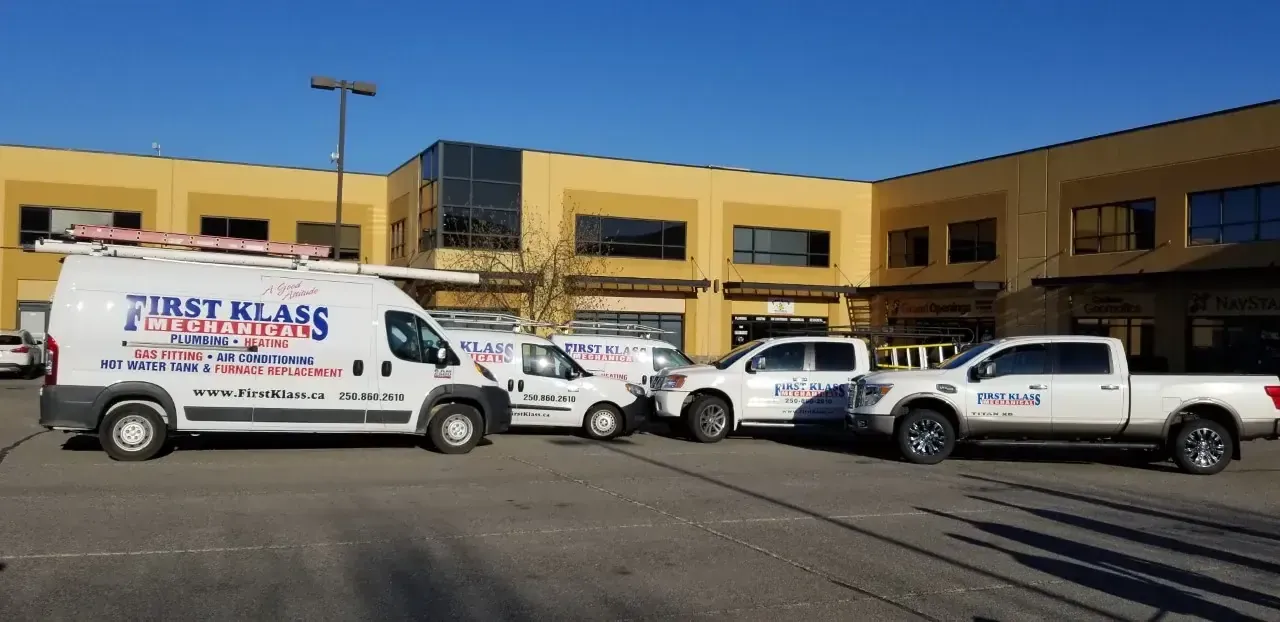 First Klass Mechanical service trucks parked outside the office